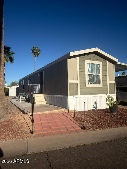 16225 North Cave Creek Road, Unit 31 Phoenix, AZ 85032 - Photo 3 of 33 a front view of a house with a yard