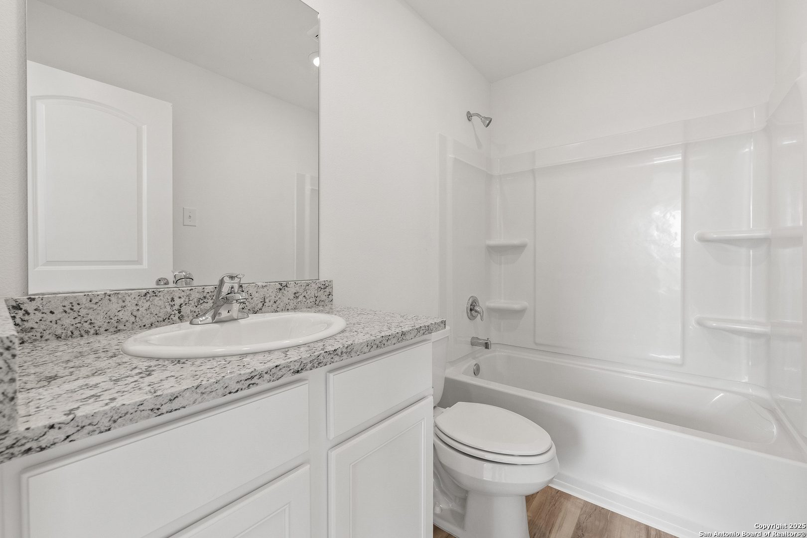 16025 Stratford Cove Lytle, TX 78052 - Photo 14 of 24 a bathroom with a granite countertop toilet sink and mirror