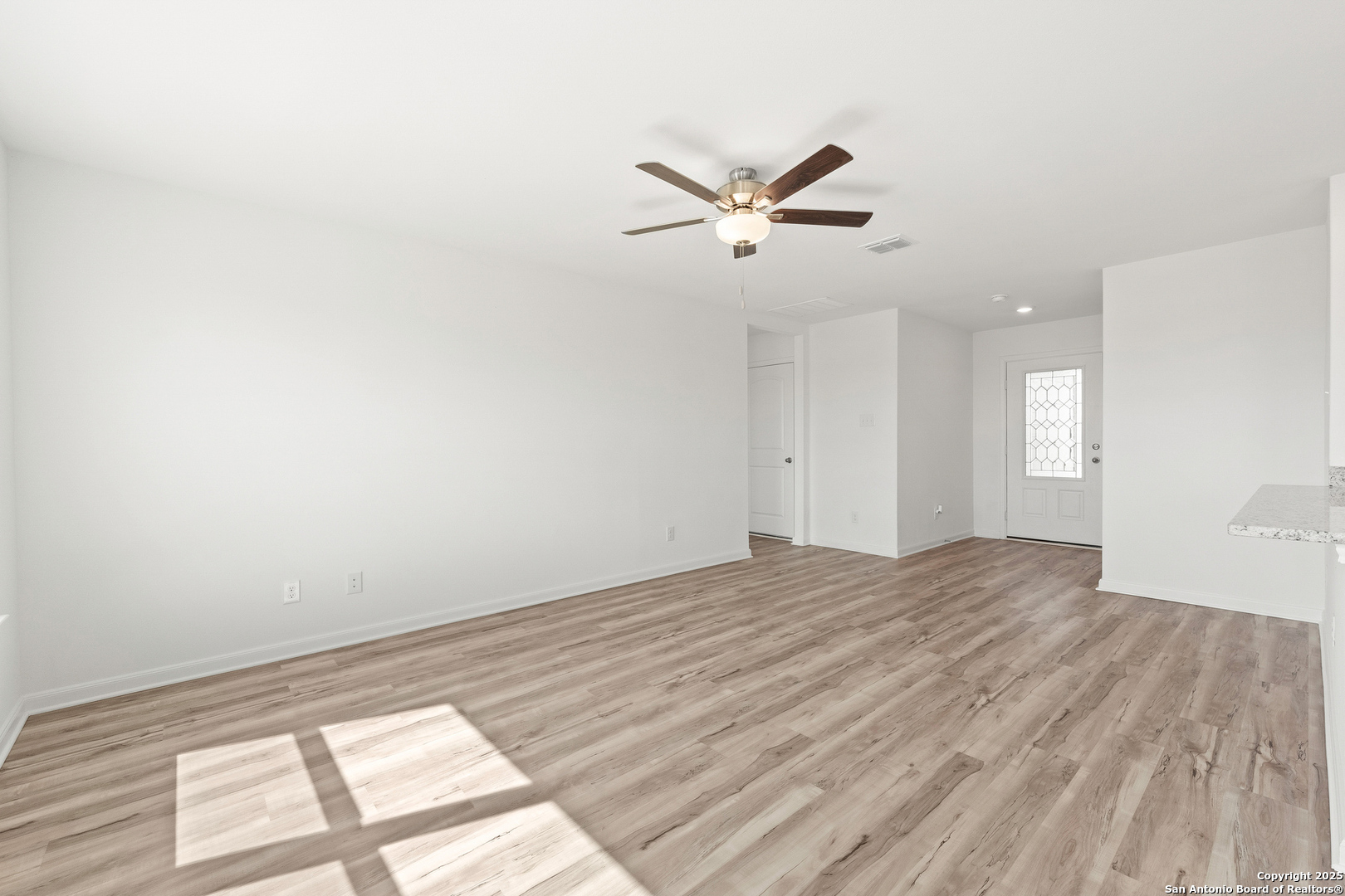 16025 Stratford Cove Lytle, TX 78052 - Photo 8 of 24 a view of empty room with wooden floor and fan