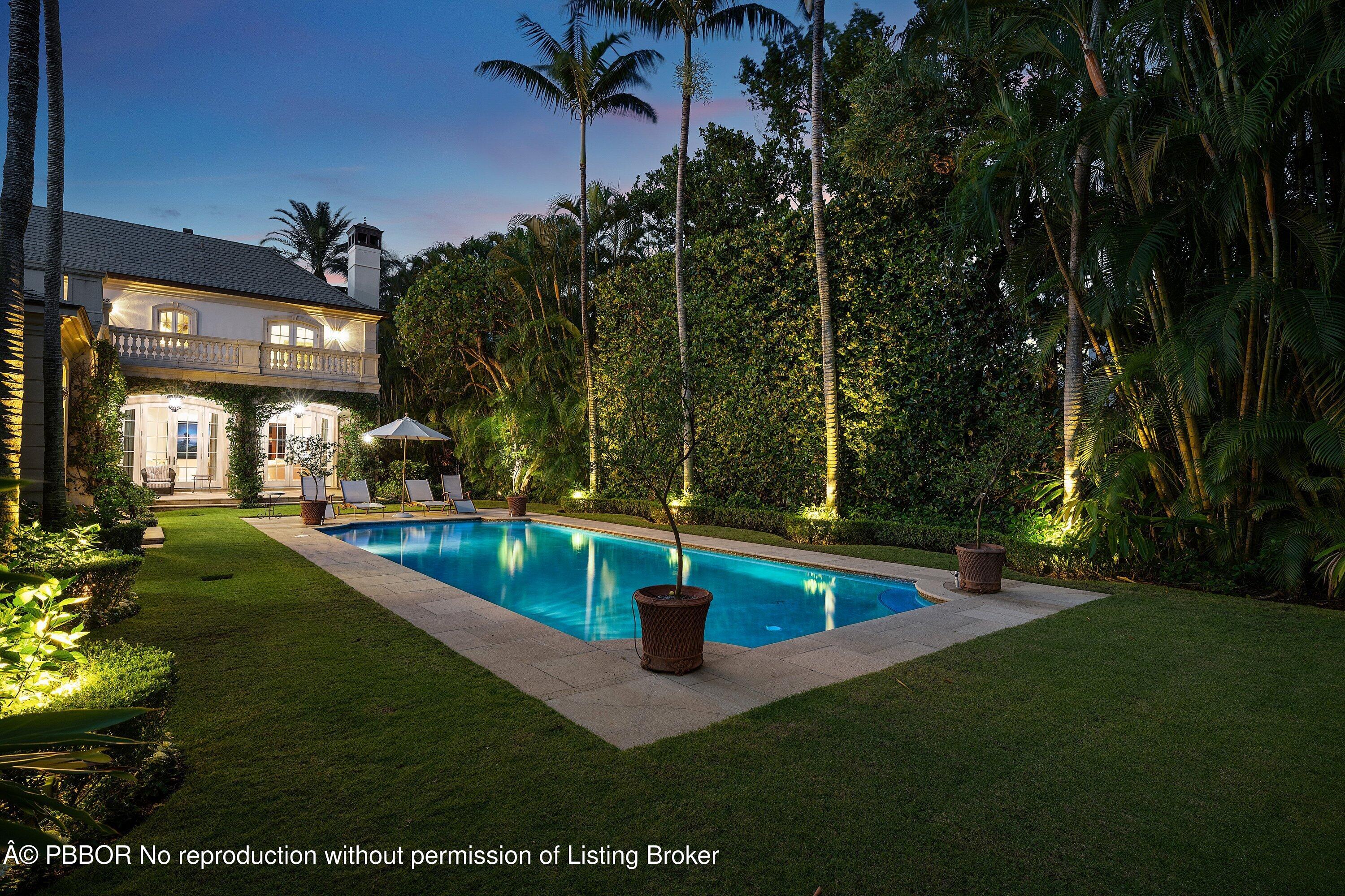 242 Wells Road Palm Beach, FL 33480 - Photo 51 of 54 a view of a swimming pool with a bench