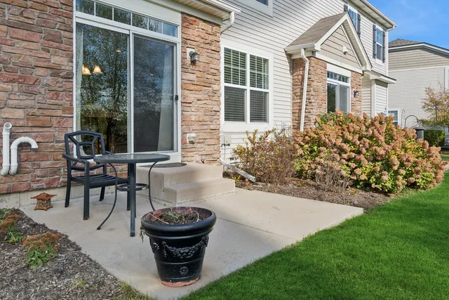 a view of a house with backyard sitting area and garden