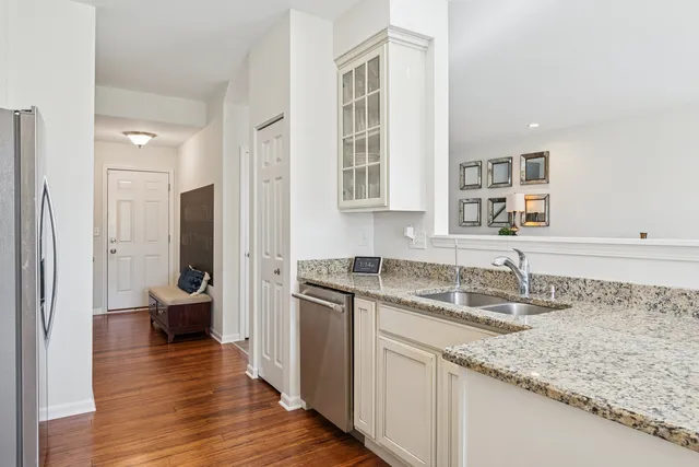 a kitchen with granite countertop a sink and wooden floor
