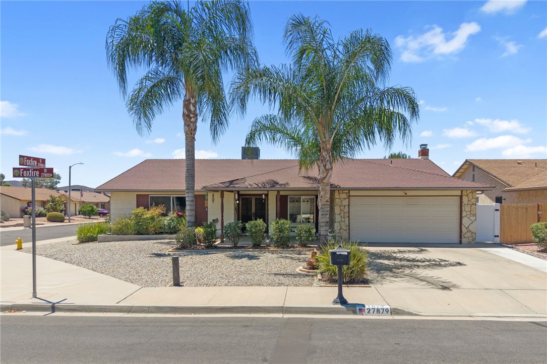 27879 Foxfire Street Menifee, CA 92586 - Photo 4 of 36 a front view of a house with garden and plants