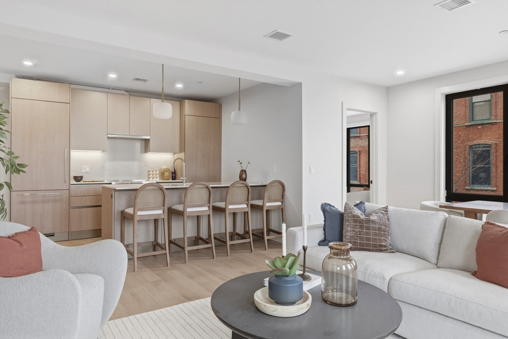 118 B Street, Unit 103 Boston, MA 02127 - Photo 1 of 12 a living room with furniture kitchen view and kitchen view