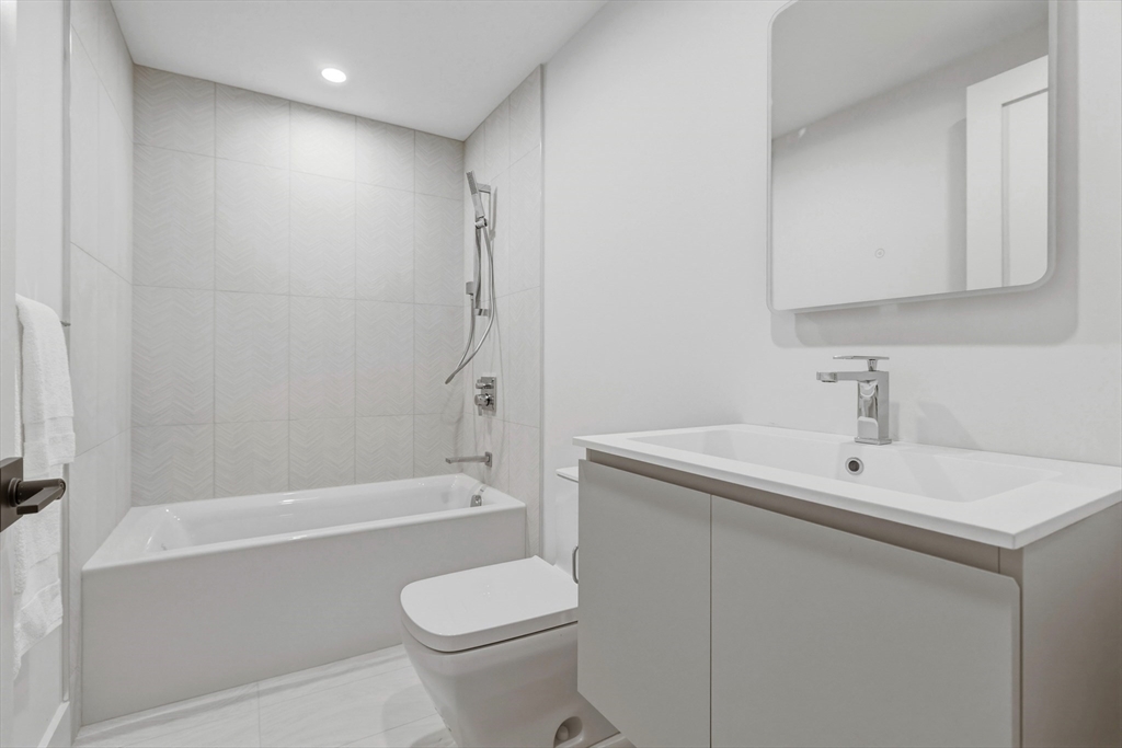 118 B Street, Unit 103 Boston, MA 02127 - Photo 8 of 12 a bathroom with a sink toilet and shower