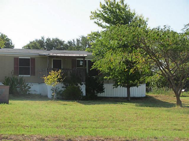 a front view of house with yard and trees