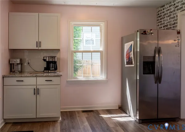 a kitchen with a refrigerator and window