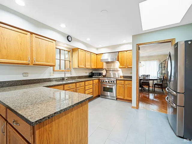 a kitchen with stainless steel appliances granite countertop a sink and cabinets
