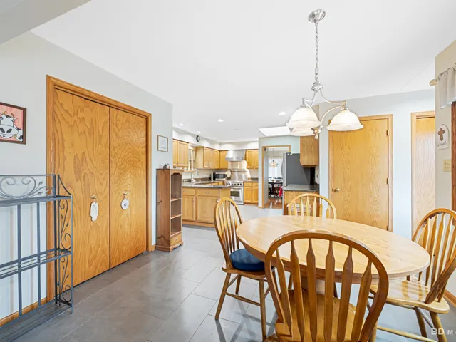 a dining room with furniture a chandelier and window