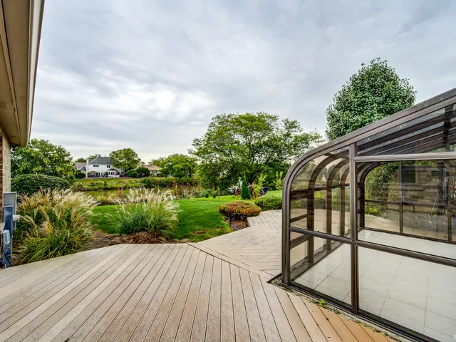a view of a wooden deck with a lake view