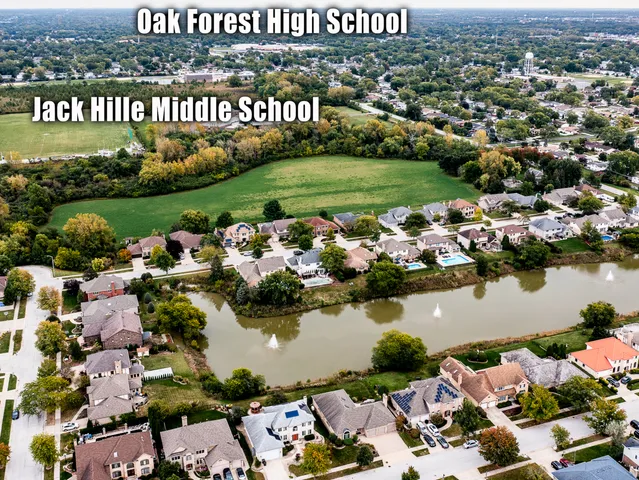 an aerial view of a house with outdoor space swimming pool and lake view