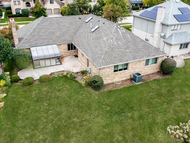 an aerial view of a house with a yard