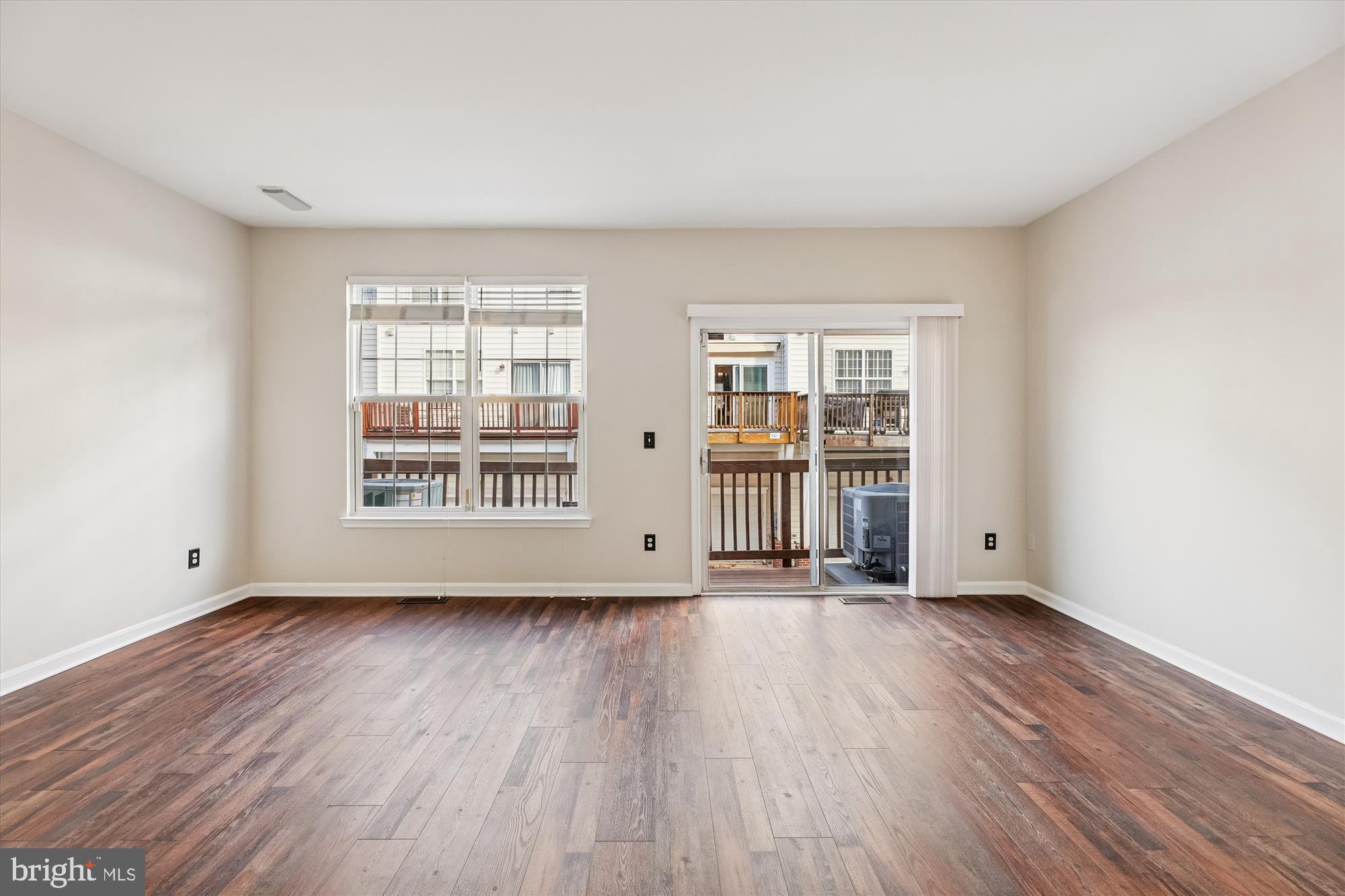 3811 Eisenhower Avenue Alexandria, VA 22304 - Photo 16 of 56 a view of an empty room with wooden floor and a window
