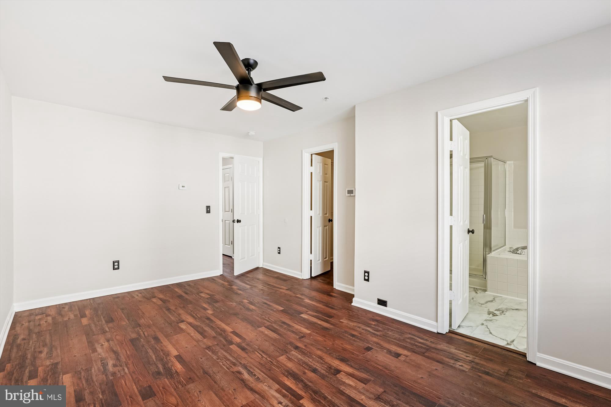 3811 Eisenhower Avenue Alexandria, VA 22304 - Photo 19 of 56 an empty room with wooden floor and windows