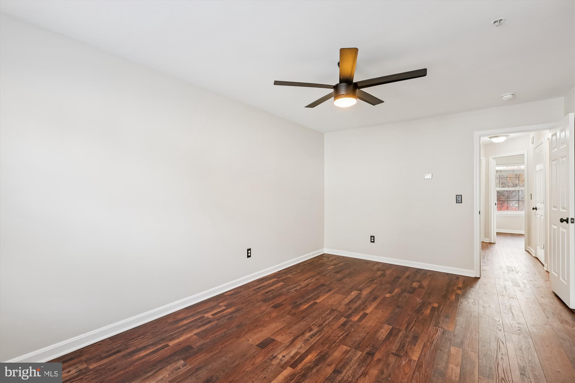 3811 Eisenhower Avenue Alexandria, VA 22304 - Photo 21 of 56 an empty room with wooden floor and windows