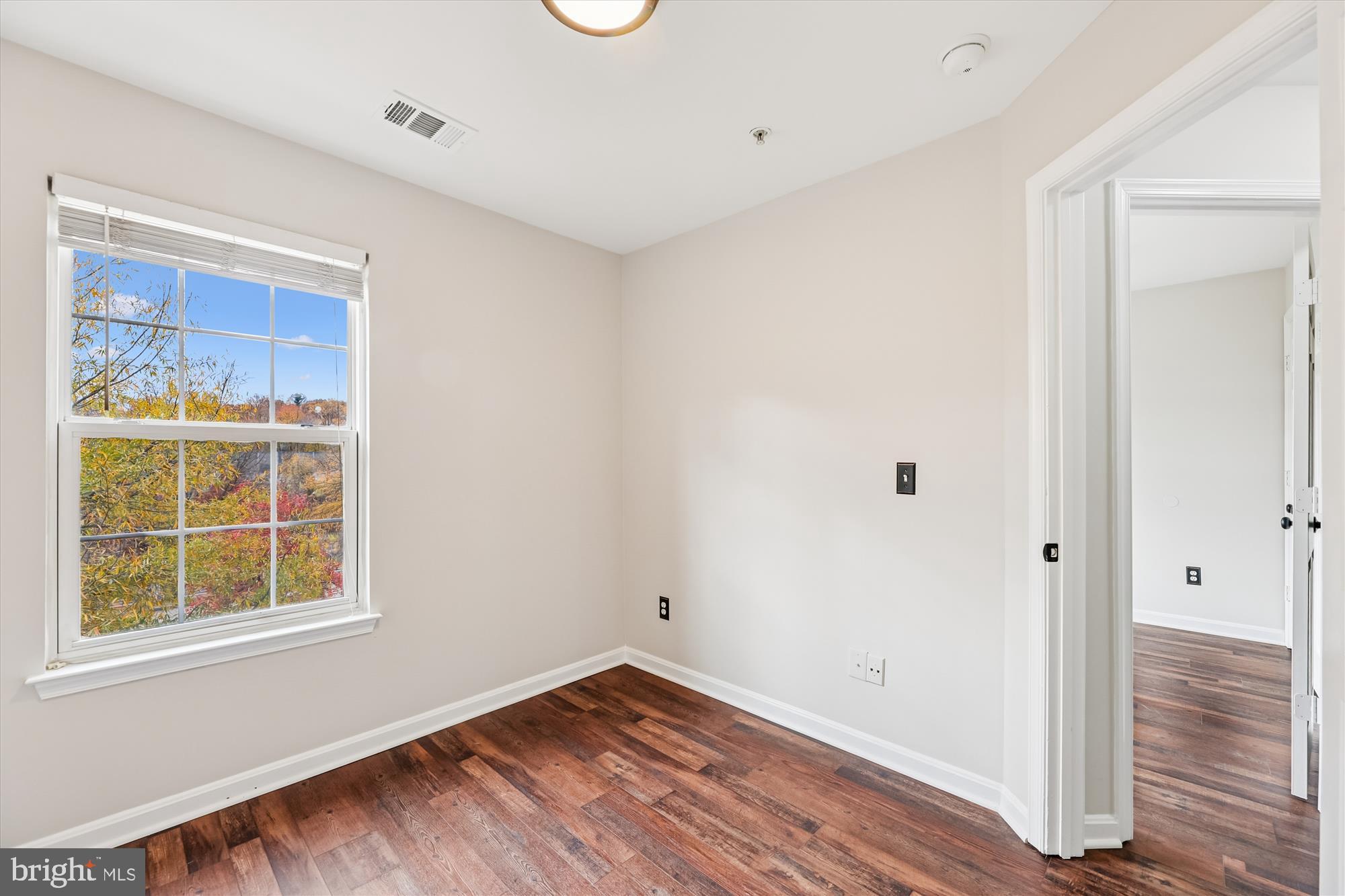 3811 Eisenhower Avenue Alexandria, VA 22304 - Photo 30 of 56 a view of an empty room with wooden floor and a window