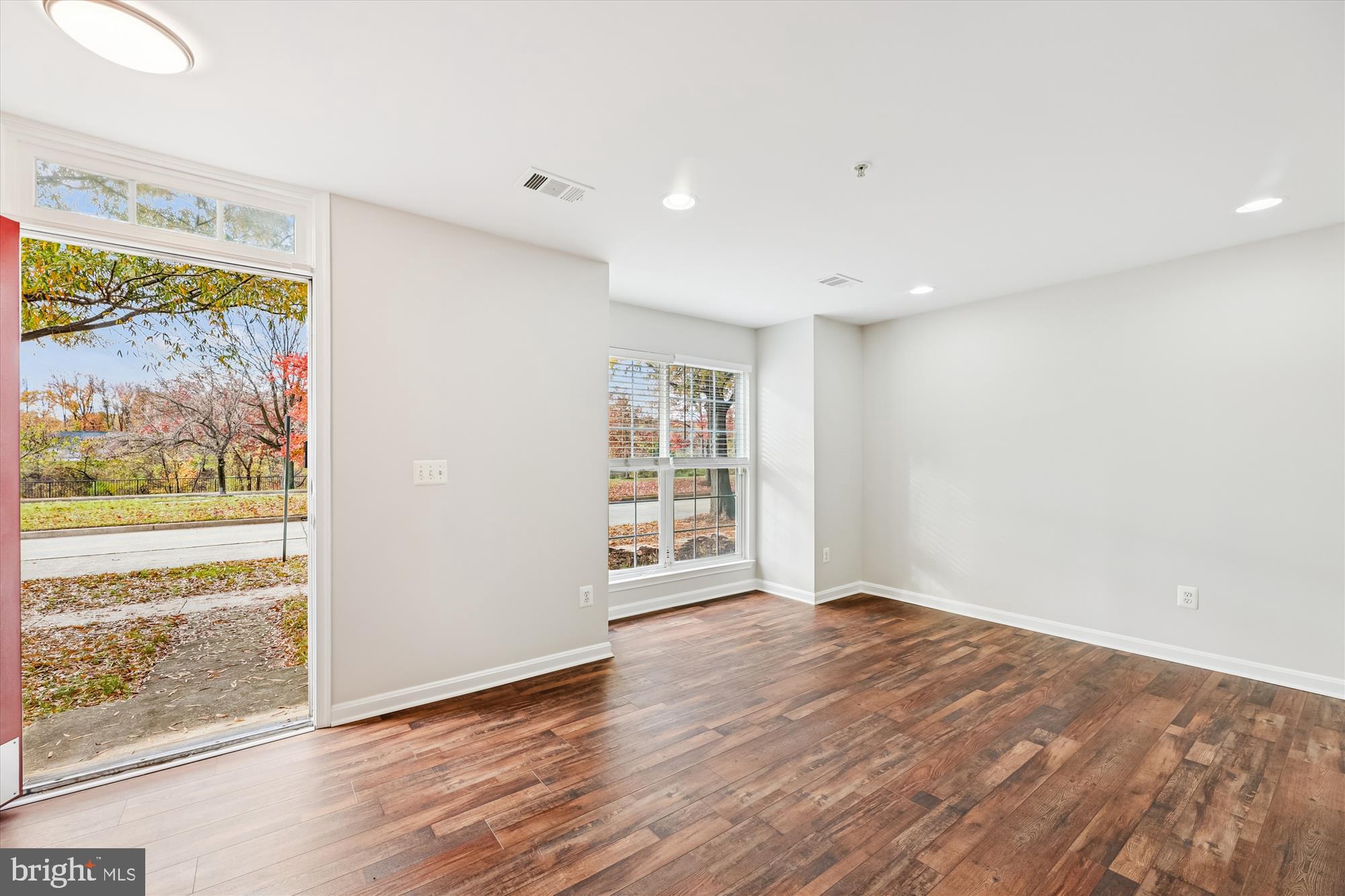 3811 Eisenhower Avenue Alexandria, VA 22304 - Photo 3 of 56 a view of an empty room with wooden floor and a window