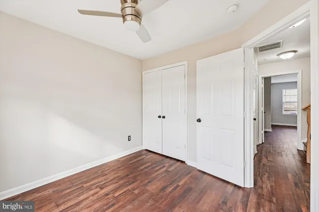 a view of a room with wooden floor