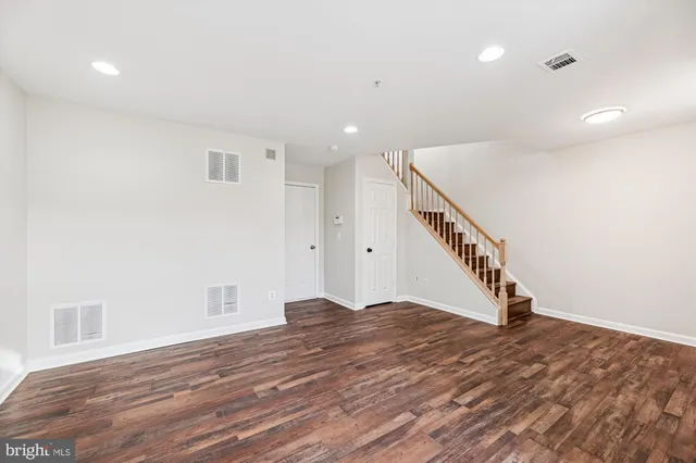 a view of an entryway with wooden floor