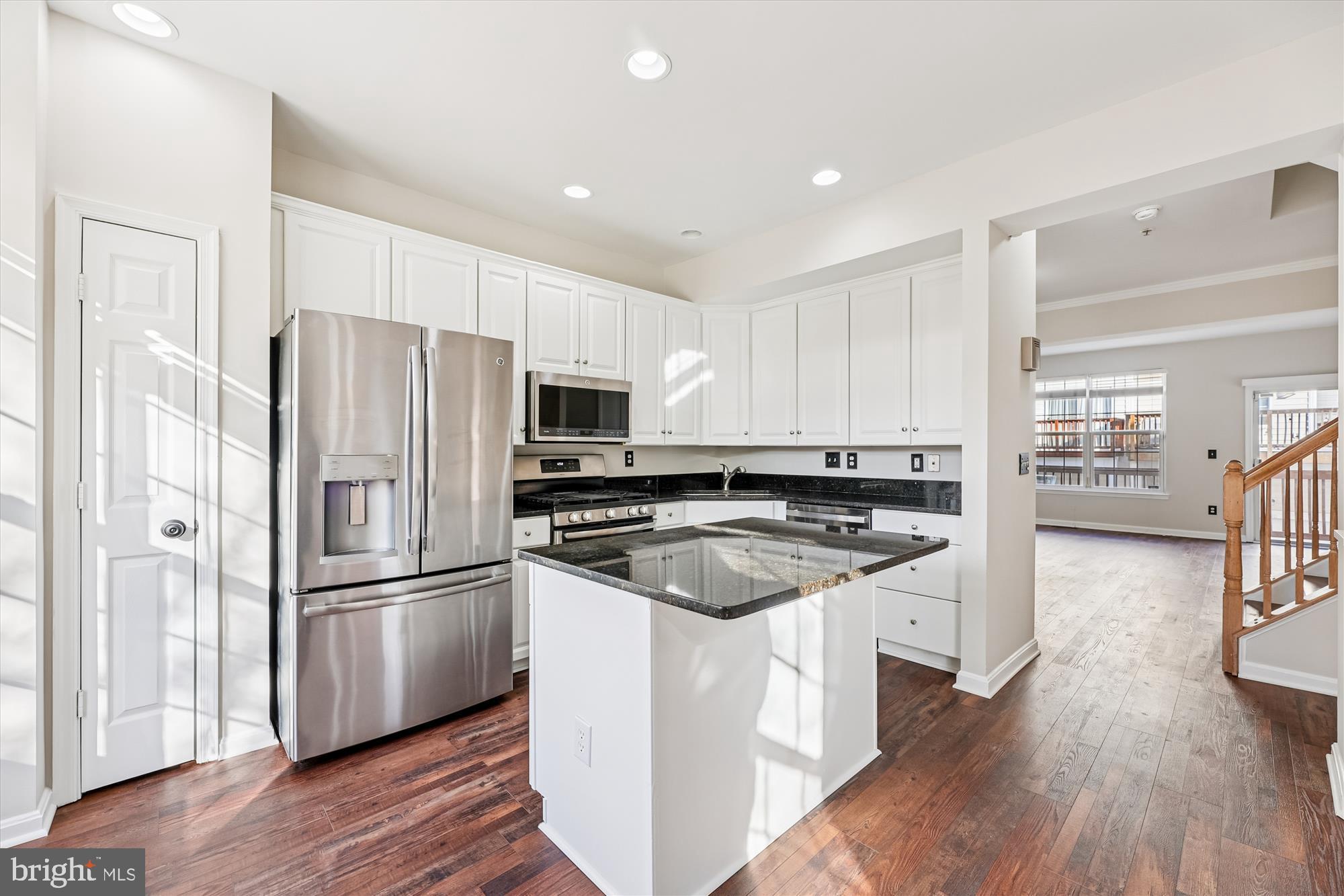 3811 Eisenhower Avenue Alexandria, VA 22304 - Photo 8 of 56 a kitchen with stainless steel appliances granite countertop a refrigerator a stove a sink and white cabinets with wooden floor
