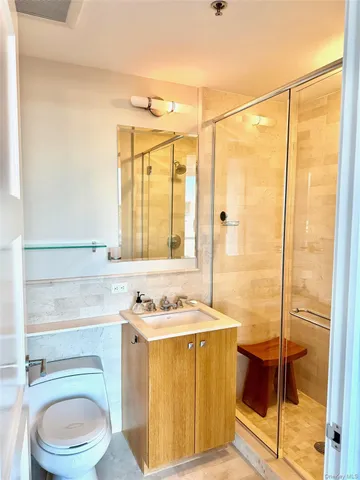 a bathroom with a sink a toilet and a shower