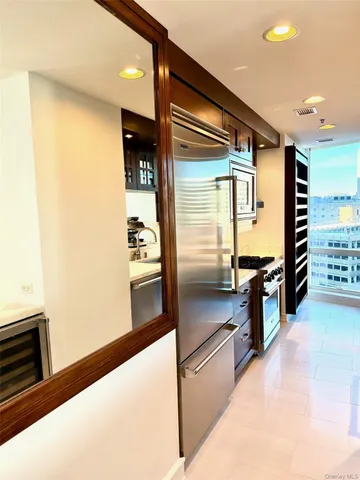 a kitchen with stainless steel appliances granite countertop a refrigerator and a stove