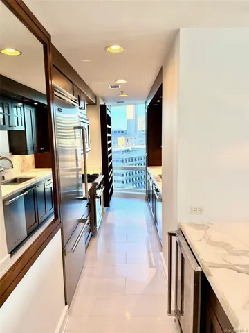 a hallway with wooden floor and furniture