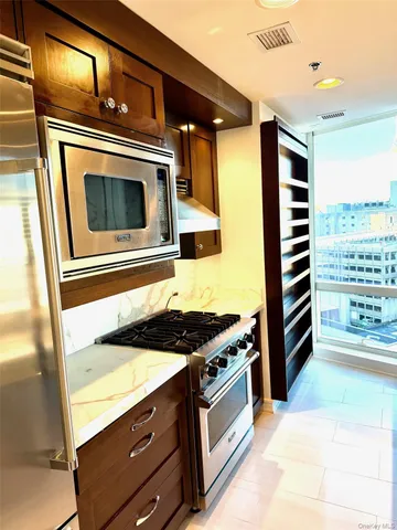 a kitchen with stainless steel appliances granite countertop a stove and a microwave