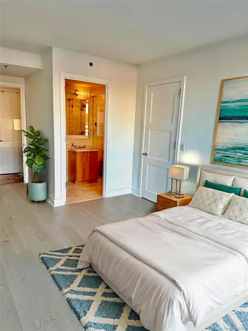 a bedroom with a bed and potted plant