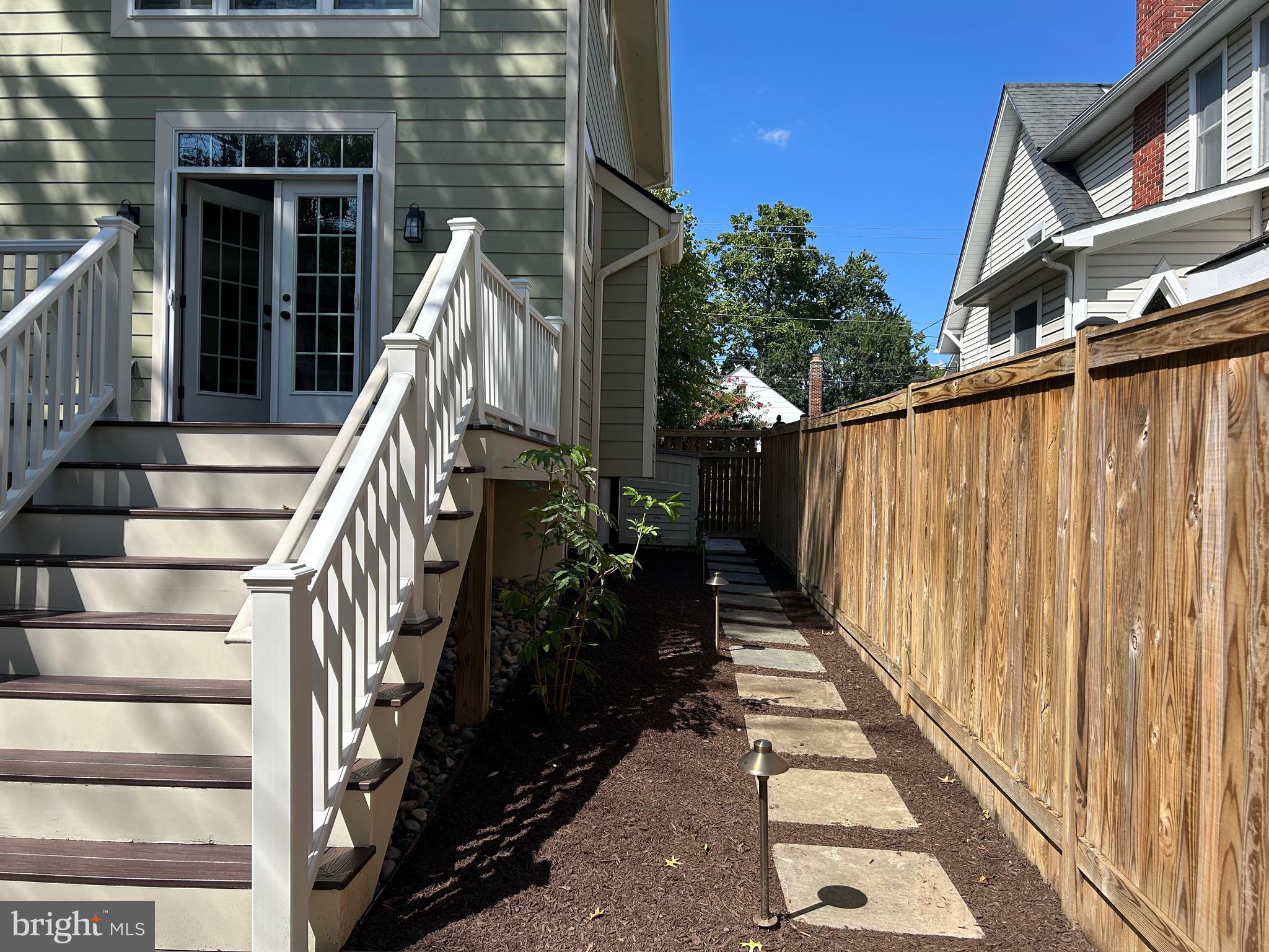 115 East Spring Street Alexandria, VA 22301 - Photo 31 of 49 a view of a house with a wooden deck stairs and a large window
