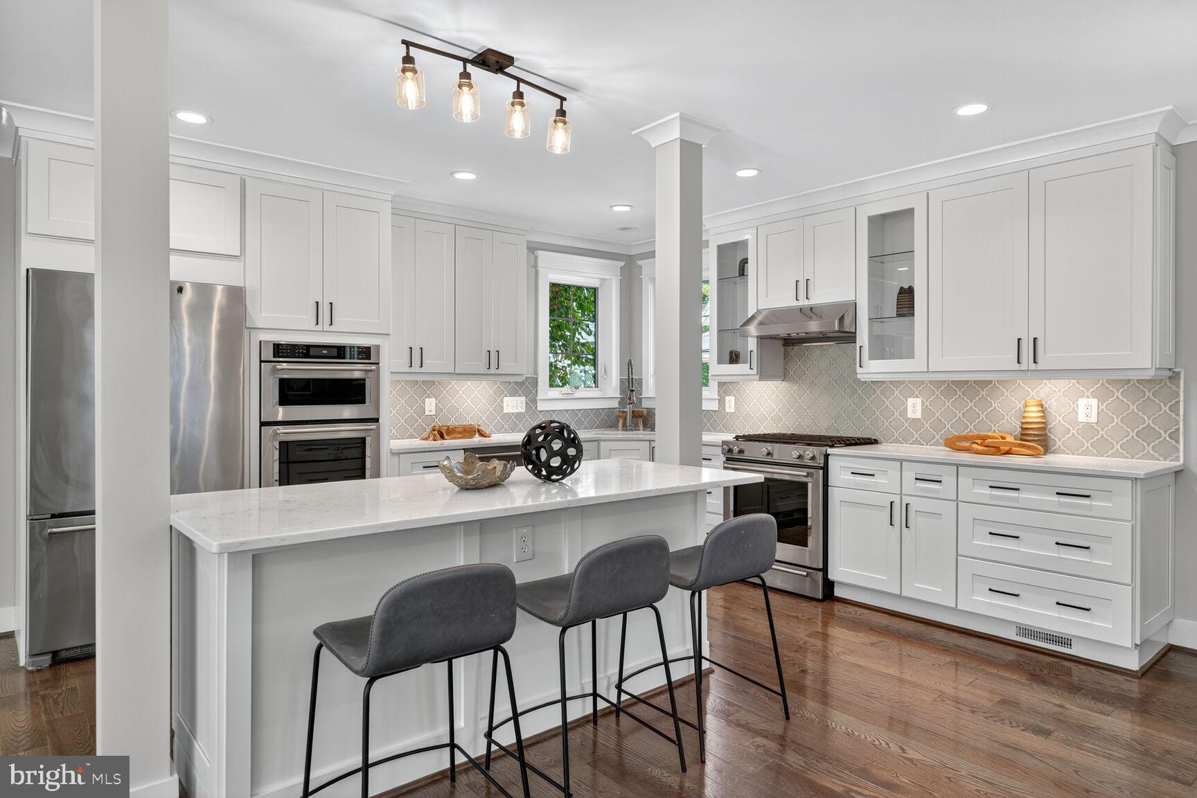 115 East Spring Street Alexandria, VA 22301 - Photo 5 of 49 a kitchen with stainless steel appliances a stove a sink island and a refrigerator
