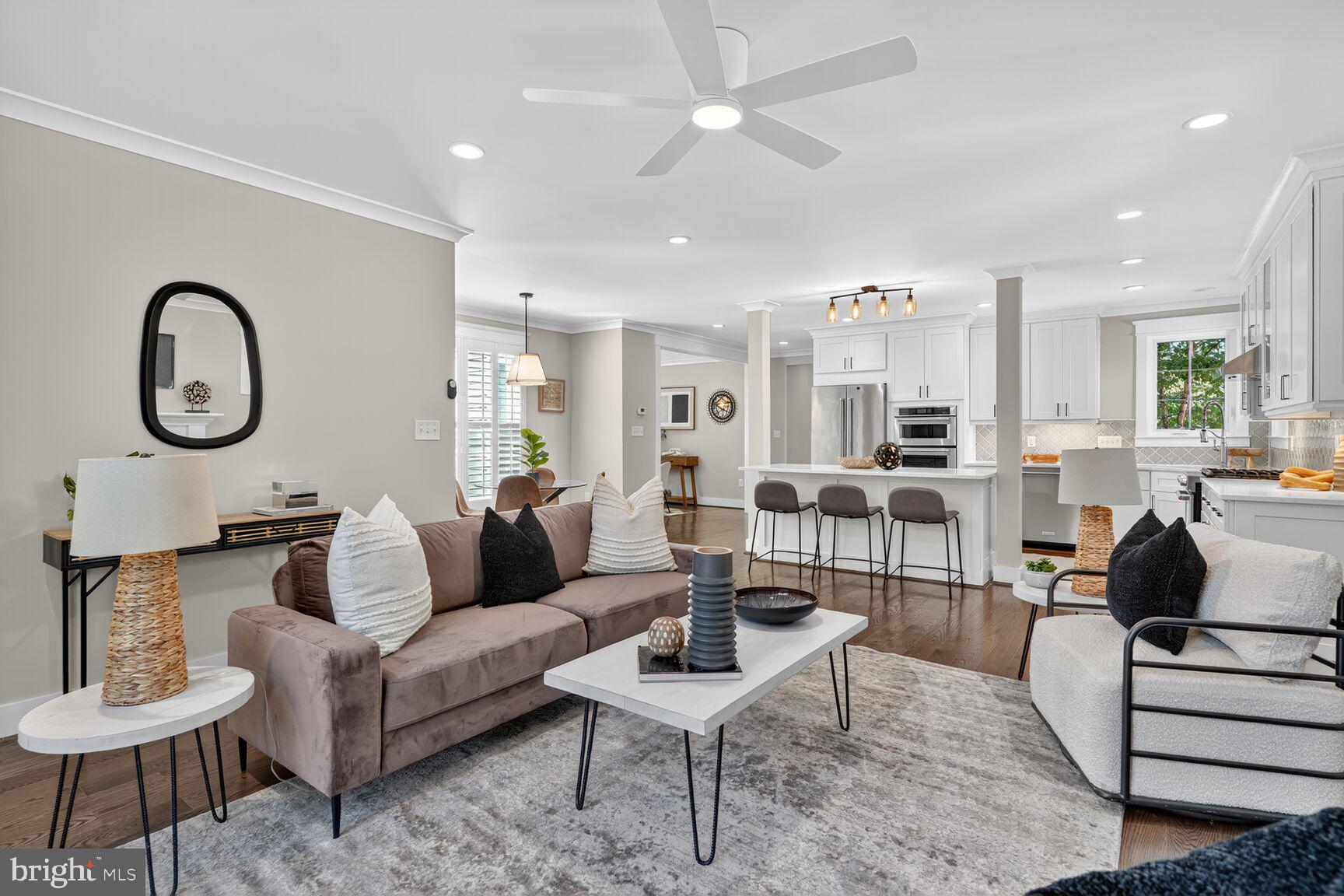 115 East Spring Street Alexandria, VA 22301 - Photo 8 of 49 a living room with furniture a rug kitchen view and a chandelier