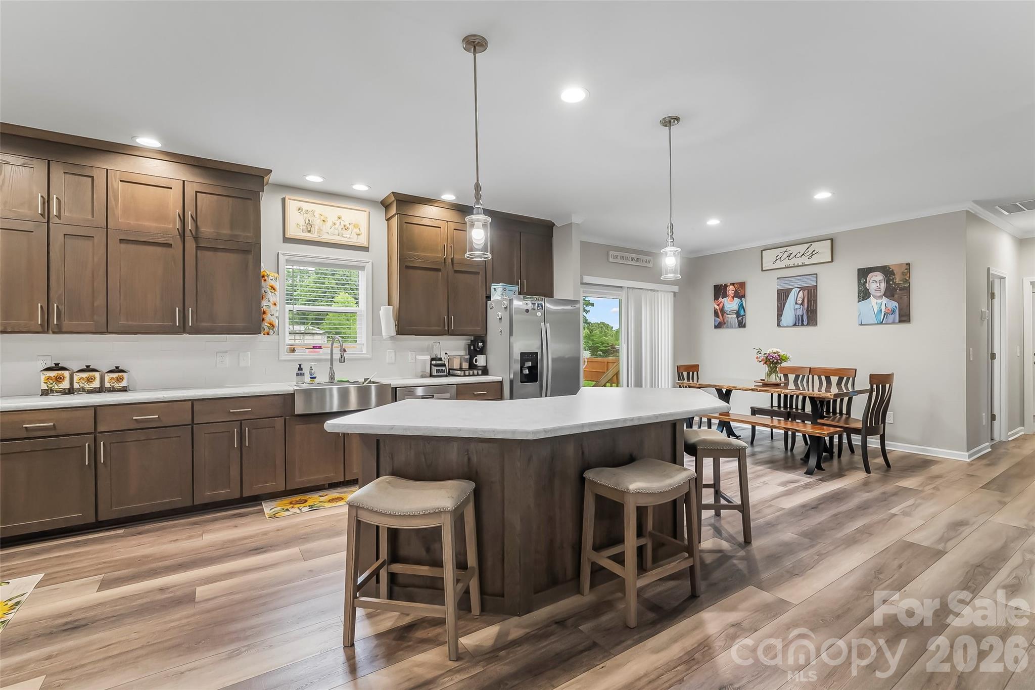 3511 Randleman Road Iron Station, NC 28080 - Photo 13 of 31 a kitchen with a dining table chairs sink and wooden floor