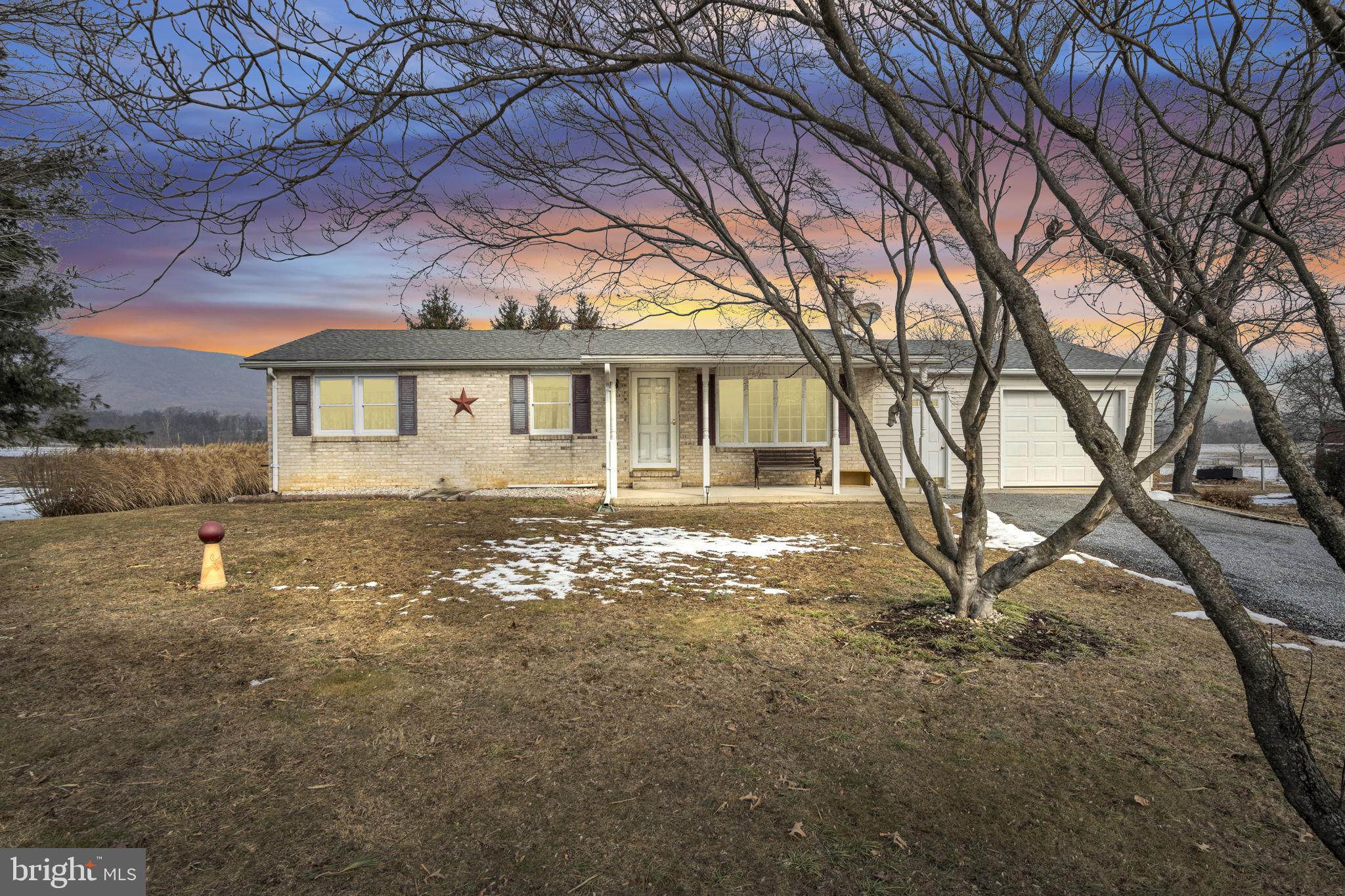647 North Middle Road Newville, PA 17241 - Photo 1 of 35 a backyard of a house with large trees and outdoor seating