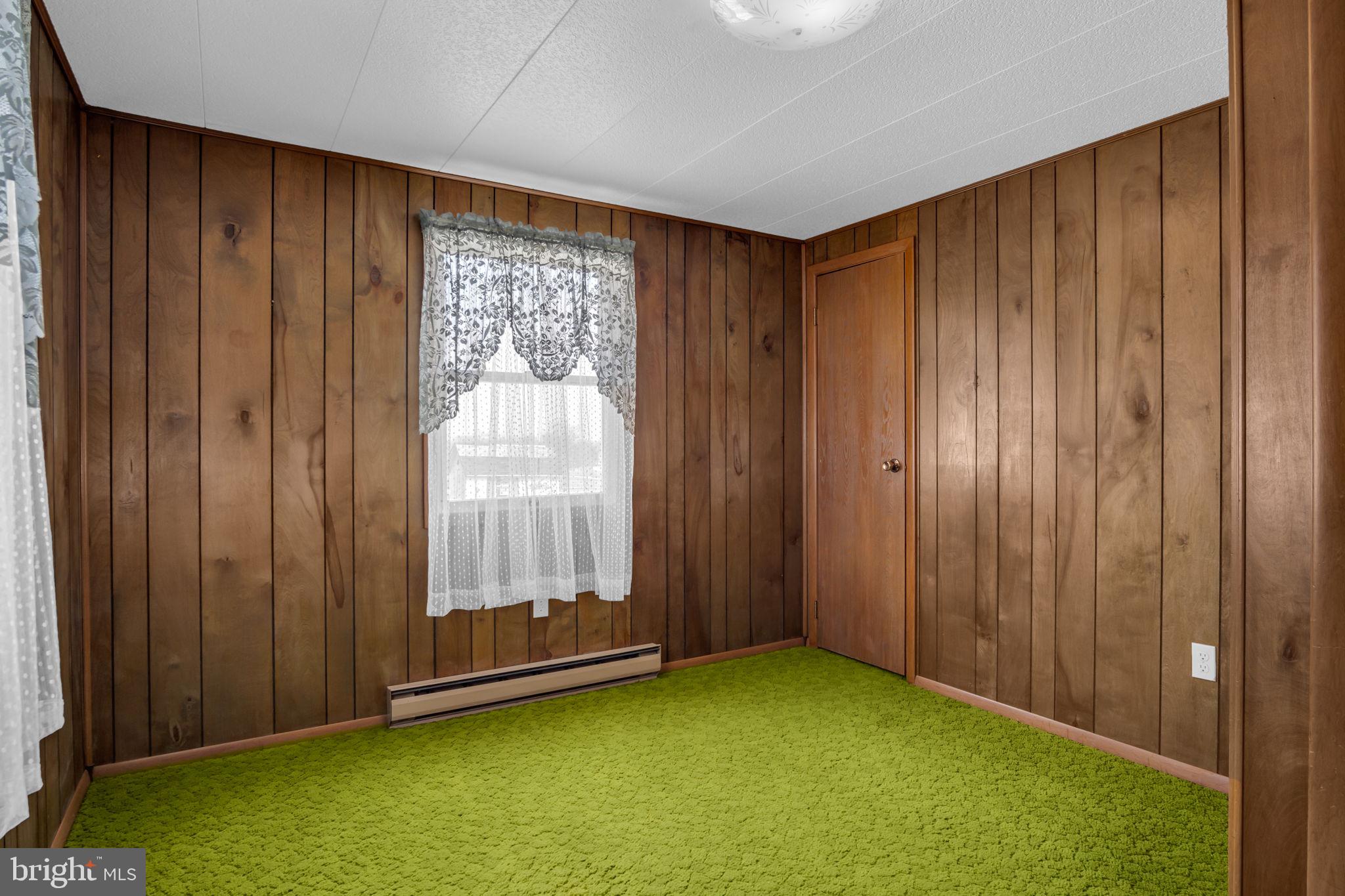 647 North Middle Road Newville, PA 17241 - Photo 17 of 35 an empty room with windows wooden walls and door