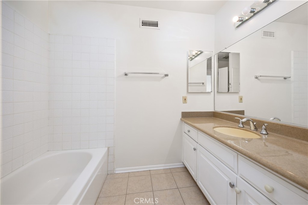 3430 Bahia Place Riverside, CA 92507 - Photo 24 of 34 a bathroom with a granite countertop sink and mirror with bathtub