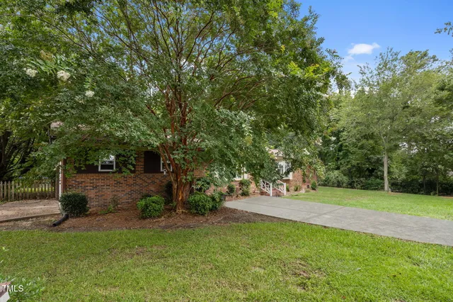 a view of an empty room with cabinet and a living room