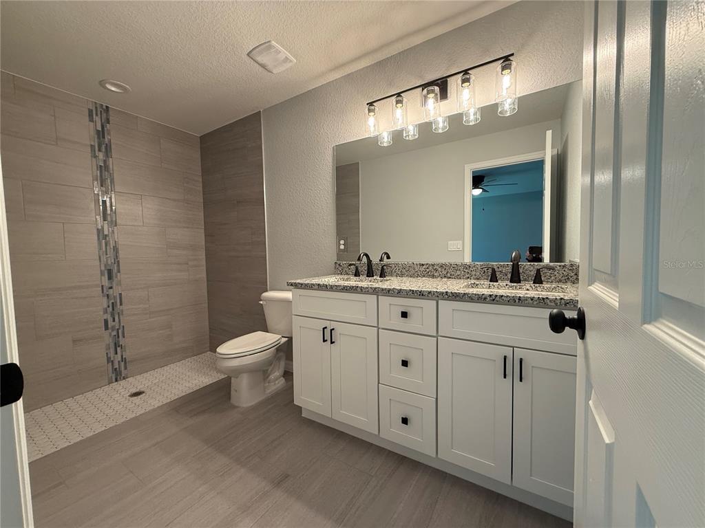 48 Locust Drive Ocala, FL 34472 - Photo 11 of 12 a bathroom with a double vanity sink toilet and shower