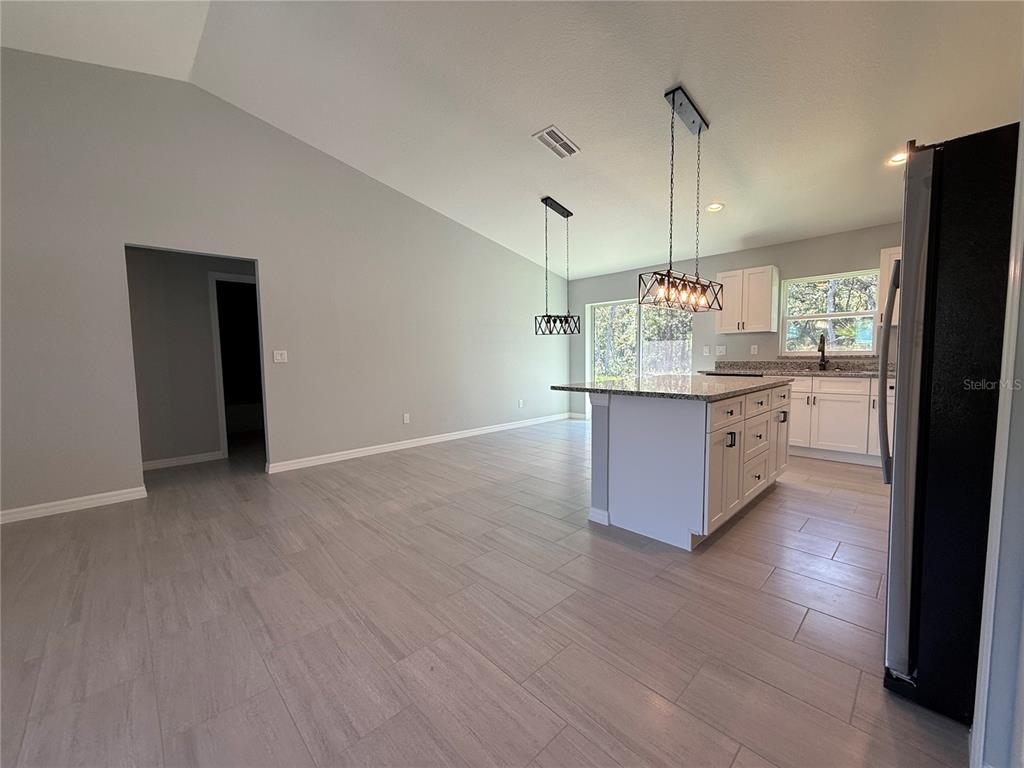 48 Locust Drive Ocala, FL 34472 - Photo 3 of 12 a kitchen with granite countertop a stove and a refrigerator