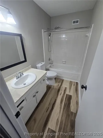 a bathroom with a shower a toilet and sink