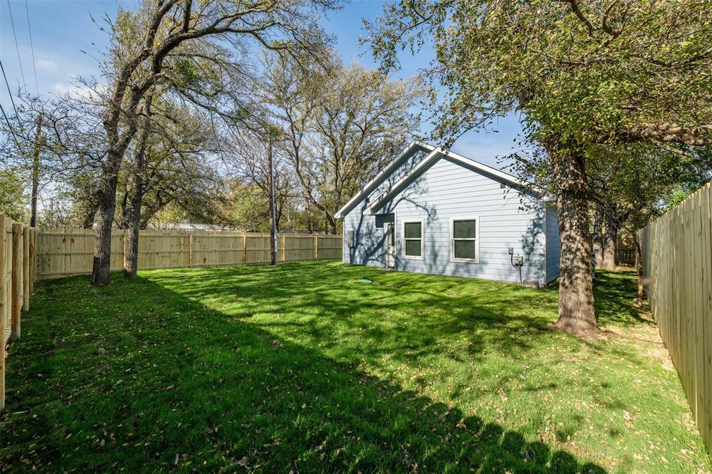 3005 Blackjack Lane Granbury, TX 76048 - Photo 12 of 30 a view of a yard in front of a house with plants and large tree