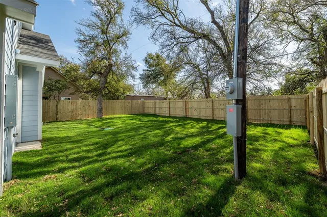 a view of a backyard with large tree