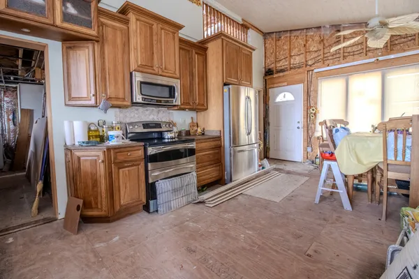 a kitchen with stainless steel appliances granite countertop a granite counter tops and a refrigerator