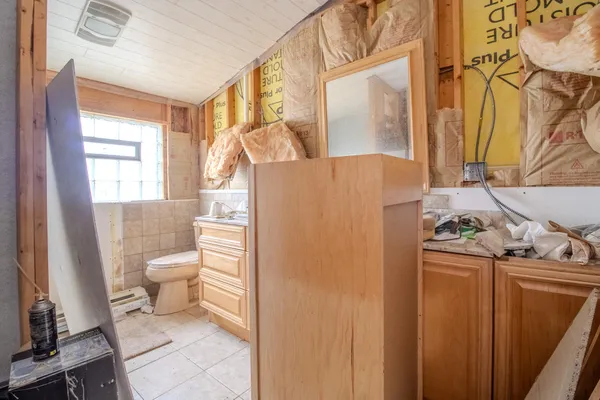 a bathroom with a granite countertop toilet and a sink