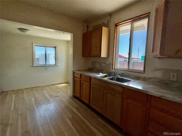 a kitchen with granite countertop wooden cabinets and a stove top oven