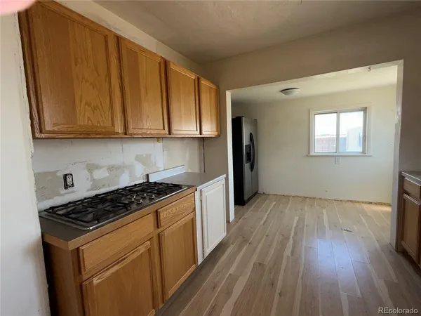 a kitchen with stainless steel appliances granite countertop a refrigerator and a stove