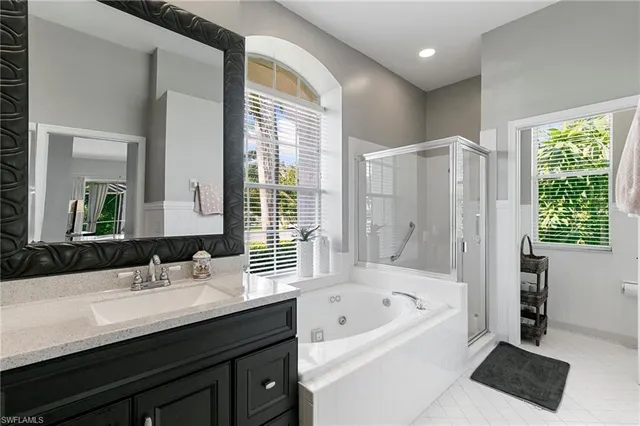 a bathroom with a bathtub sink and mirror