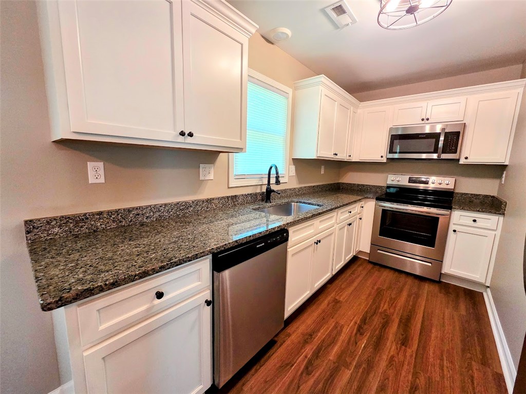 509 Elrod Road Piedmont, SC 29673 - Photo 9 of 28 Well-appointed kitchen featuring granite countertops, white cabinetry, and stainless steel appliances.
