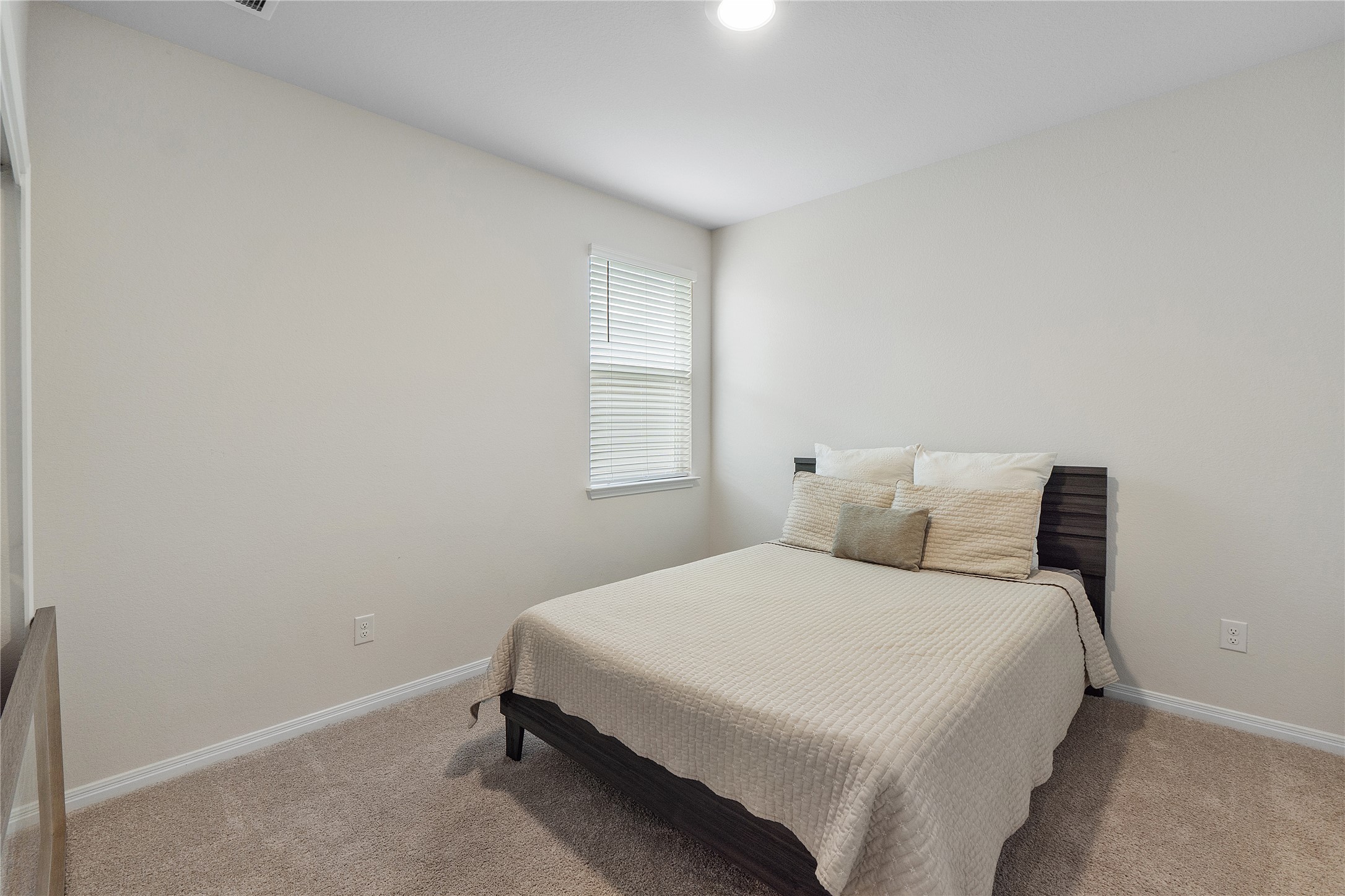 217 Evergreen Sumac Loop Kyle, TX 78640 - Photo 15 of 20 A cozy bedroom with a neutral palette and ample light offers a peaceful retreat.