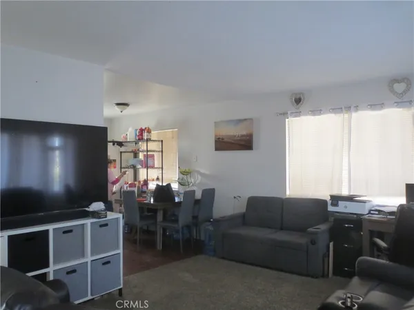a living room with furniture a projector and a flat screen tv